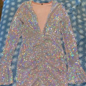 Shimmery dress with peachy pink undertones, deep v neck, flared arms at wrist